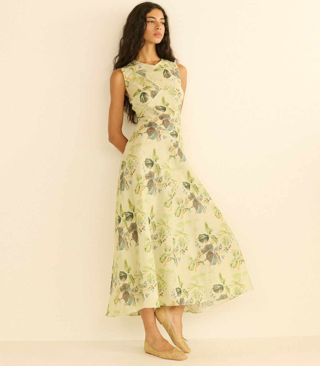 Woman wearing a floral dress against a plain background